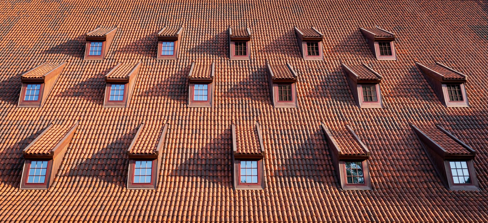 Traditional roof with windows covered by ceramic tiles